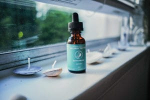 Releaf Wellness Tincture Container on a window sill